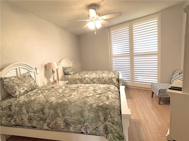 bedroom with multiple windows, light hardwood / wood-style flooring, and ceiling fan