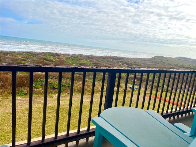 balcony featuring a beach view and a water view