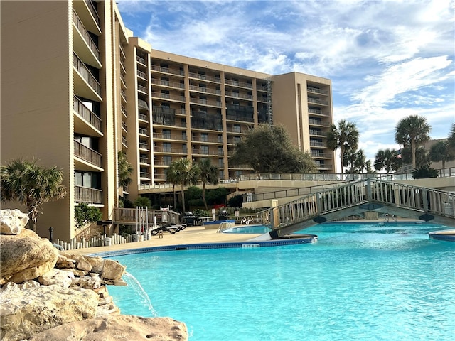 view of pool with pool water feature