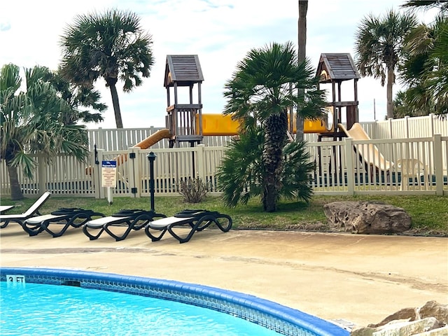 view of swimming pool with a playground