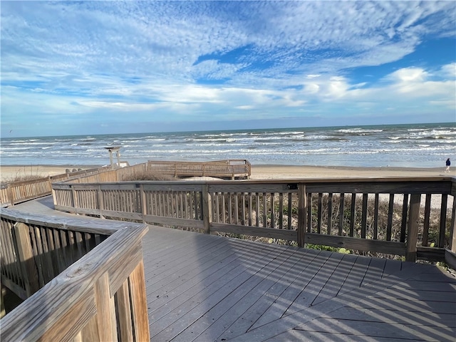 deck with a water view and a beach view