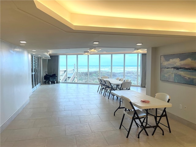 dining room featuring light tile patterned floors and floor to ceiling windows