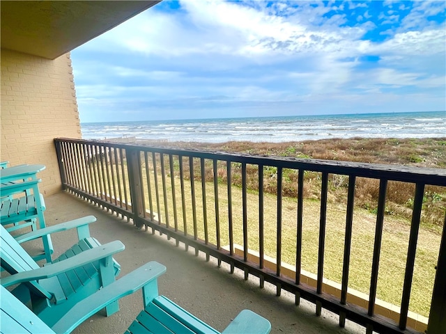 balcony featuring a water view and a view of the beach