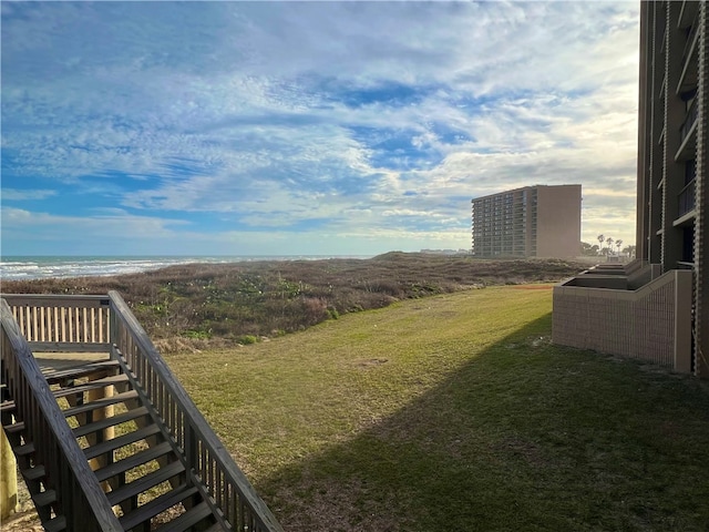 view of yard featuring a view of the beach and a water view