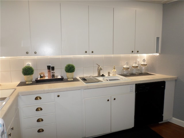 kitchen featuring white cabinets, sink, dishwasher, and tasteful backsplash