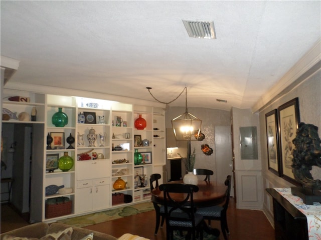 dining area with ornamental molding, a textured ceiling, a notable chandelier, dark wood-type flooring, and lofted ceiling