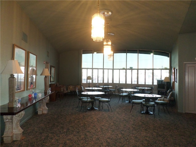 carpeted dining space with lofted ceiling and a chandelier