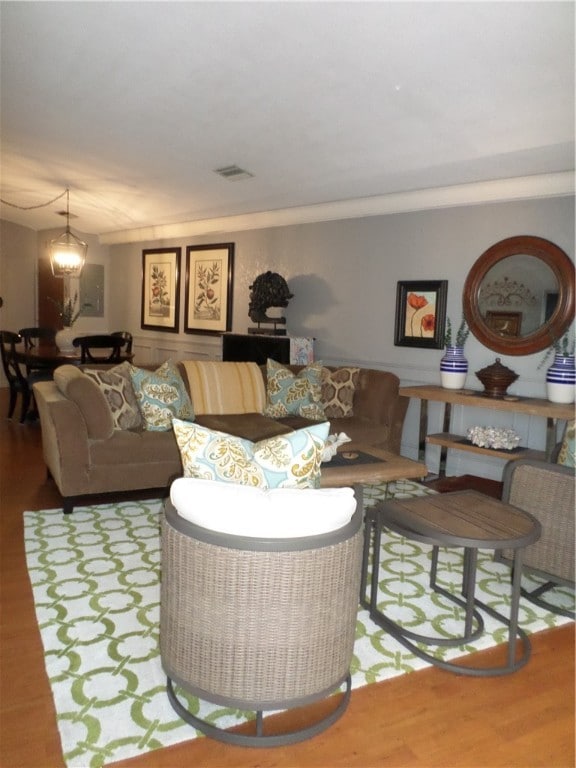 living room with hardwood / wood-style floors and a chandelier