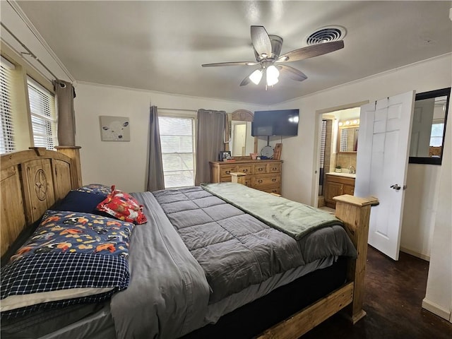 bedroom featuring connected bathroom, baseboards, visible vents, and ceiling fan