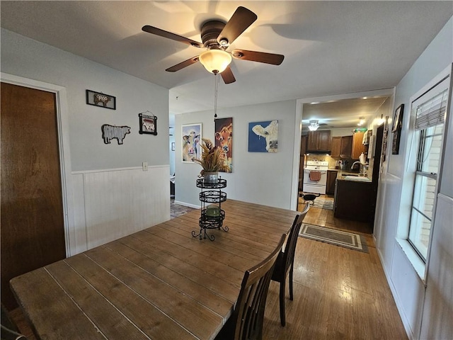 dining area with a ceiling fan and wood finished floors