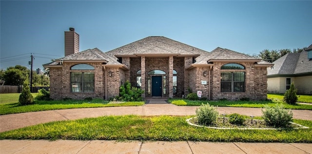 french provincial home featuring a front yard