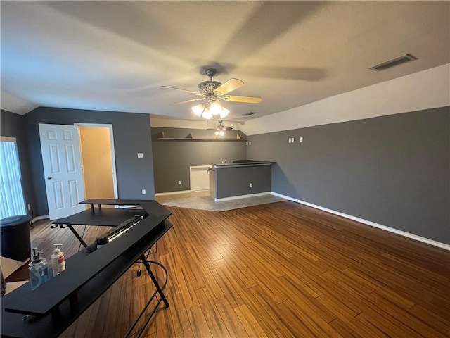 interior space with light hardwood / wood-style floors, lofted ceiling, and ceiling fan