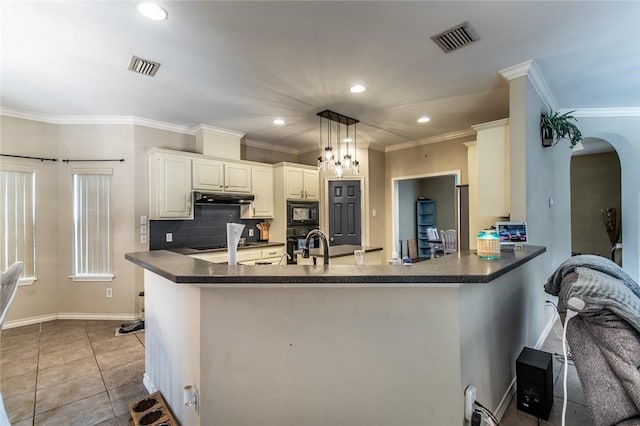 kitchen featuring black appliances, kitchen peninsula, ornamental molding, pendant lighting, and decorative backsplash