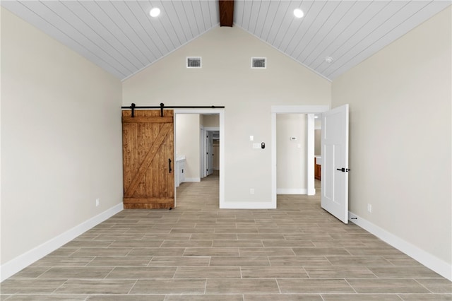 13942 Ketch St, Corpus Christi, TX 78418 - unfurnished bedroom featuring recessed lighting, high vaulted ceiling, beam ceiling, a barn door, and light wood-type flooring
