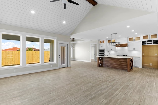 13942 Ketch St, Corpus Christi, TX 78418 - kitchen with light countertops, ceiling fan, white cabinets, appliances with stainless steel finishes, and open floor plan