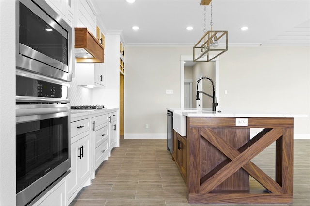 13942 Ketch St, Corpus Christi, TX 78418 - kitchen featuring stainless steel appliances, crown molding, light countertops, recessed lighting, and white cabinets