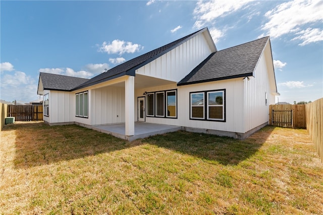 13942 Ketch St, Corpus Christi, TX 78418 - rear view of house with a shingled roof, a patio area, a fenced backyard, and board and batten siding