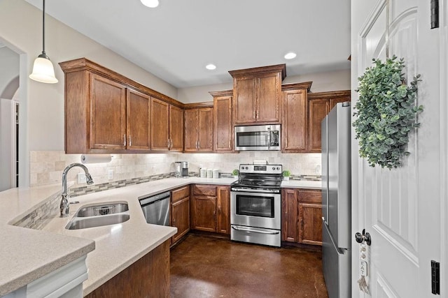 kitchen featuring backsplash, hanging light fixtures, stainless steel appliances, and sink