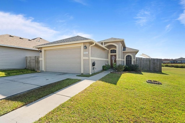 view of front of property with a front yard and a garage