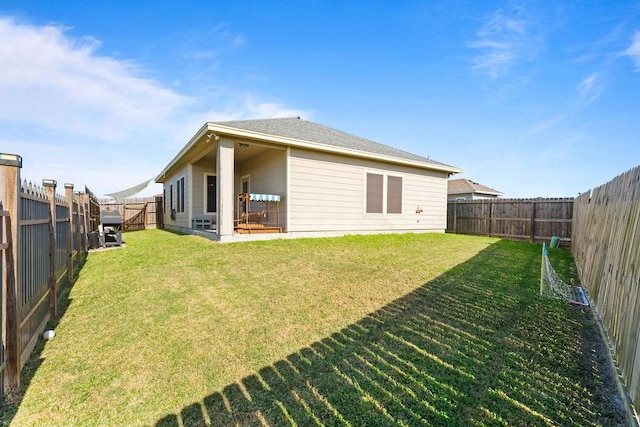 rear view of property featuring a yard