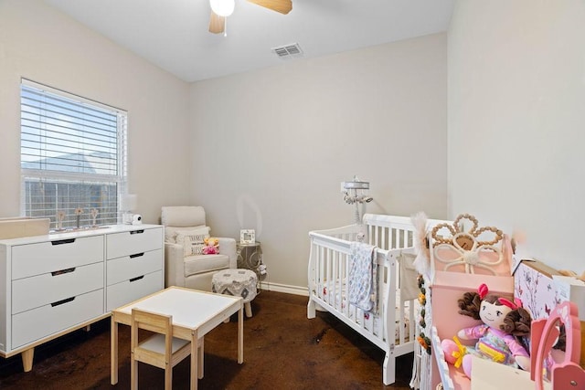 bedroom with ceiling fan and a crib