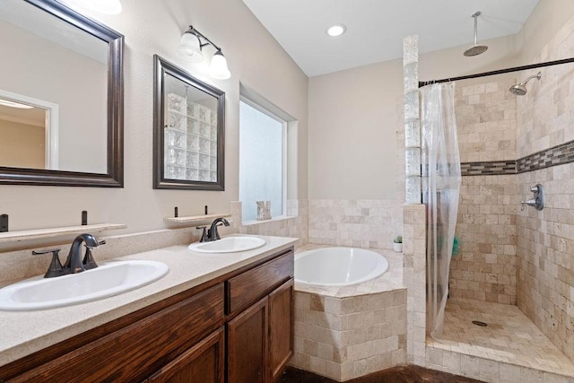 bathroom featuring vanity and shower with separate bathtub