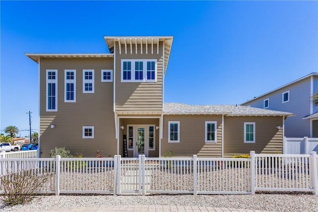 back of property with a fenced front yard