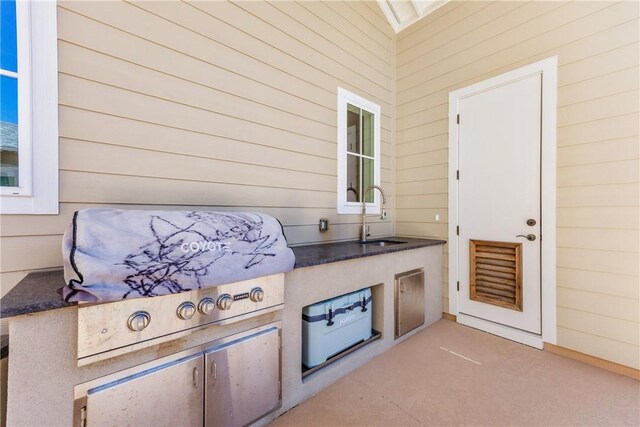 view of patio with an outdoor kitchen, a grill, and a sink