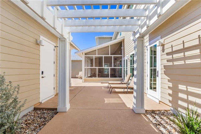 view of patio with a pergola and a sunroom