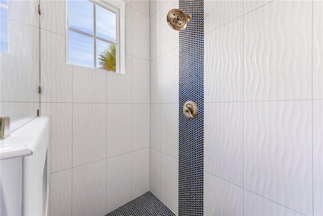 bathroom with tiled shower