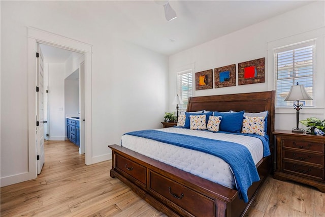 bedroom featuring baseboards and light wood-style flooring