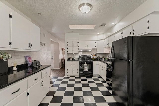1313 E Cherrystone Dr, Corpus Christi, TX 78412 - kitchen featuring black appliances, dark floors, under cabinet range hood, white cabinetry, and a textured ceiling