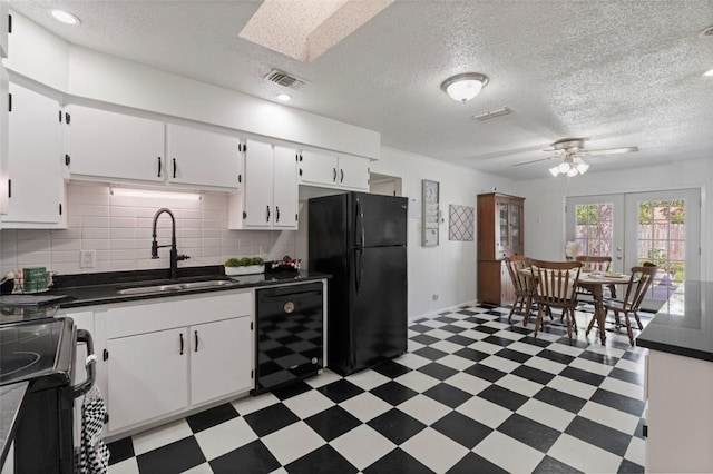 1313 E Cherrystone Dr, Corpus Christi, TX 78412 - kitchen with black appliances, light floors, dark countertops, white cabinets, and a textured ceiling