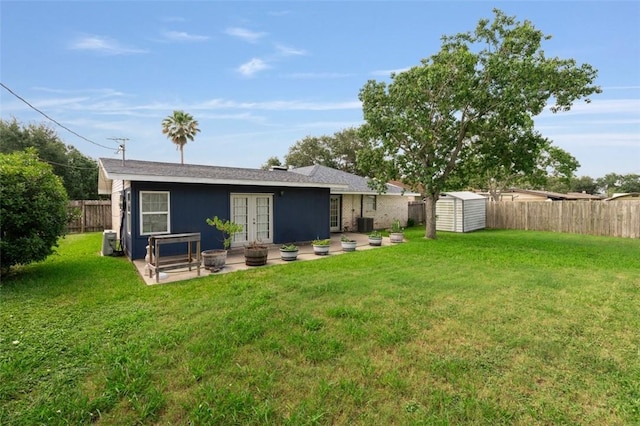 1313 E Cherrystone Dr, Corpus Christi, TX 78412 - back of house with french doors, a shed, a fenced backyard, a patio, and stucco siding