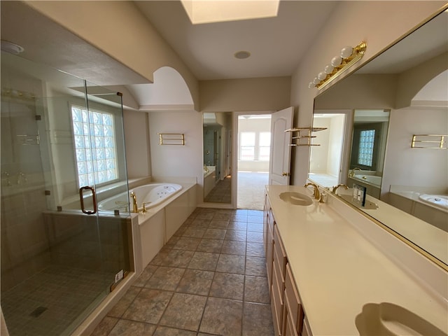 bathroom featuring tile patterned flooring, vanity, and plus walk in shower