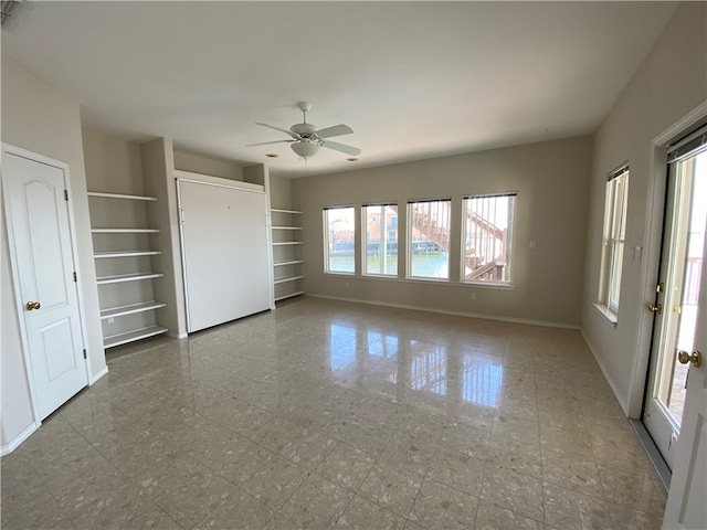 interior space with ceiling fan