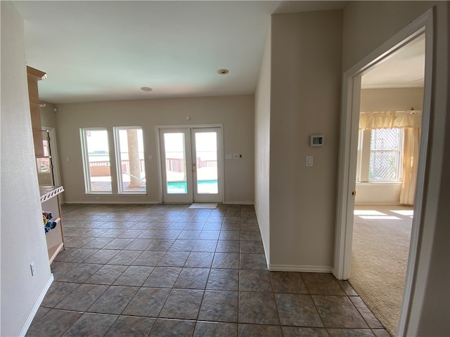 doorway featuring dark carpet