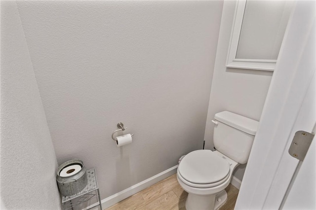 13950 Ketch St, Corpus Christi, TX 78418 - bathroom featuring baseboards, toilet, and wood finished floors