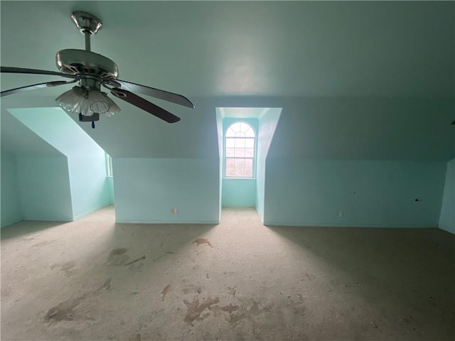 additional living space featuring ceiling fan and vaulted ceiling