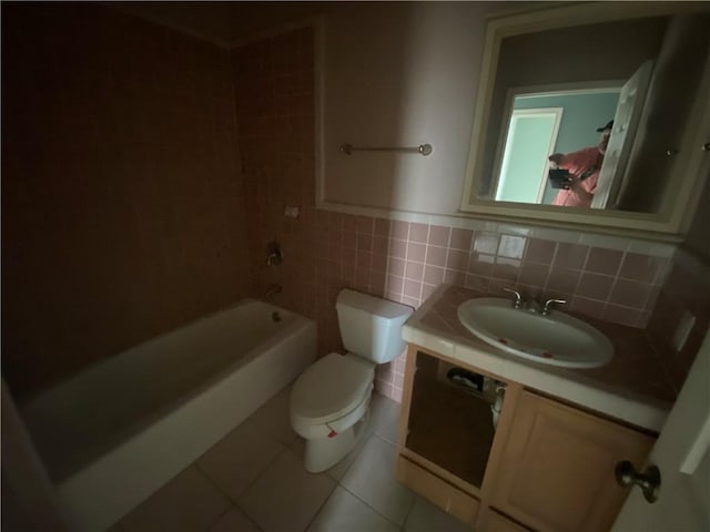 full bathroom featuring bathtub / shower combination, vanity, toilet, and tile patterned flooring