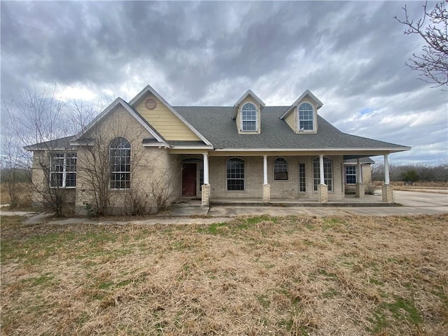 view of front facade featuring covered porch and a front lawn