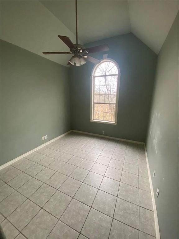 tiled spare room featuring lofted ceiling and ceiling fan