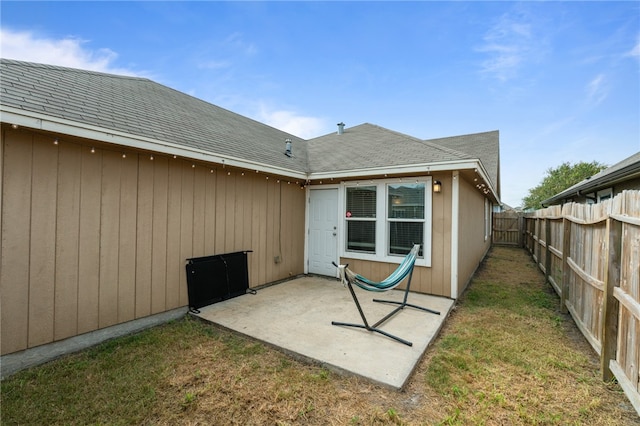 rear view of house with a patio and a lawn