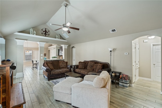 living room with light hardwood / wood-style floors, ceiling fan, and high vaulted ceiling