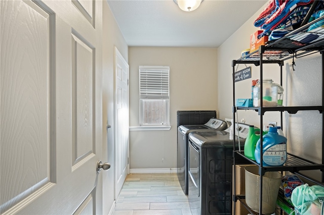 laundry room featuring light hardwood / wood-style flooring and washing machine and clothes dryer