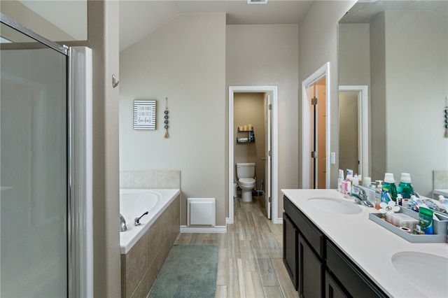 full bathroom featuring hardwood / wood-style floors, shower with separate bathtub, vanity, and toilet