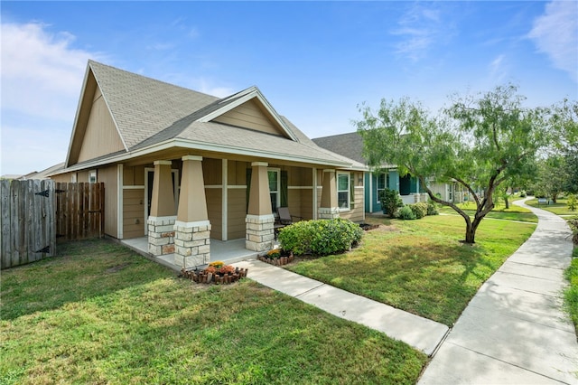 view of front of house with a front yard and a porch