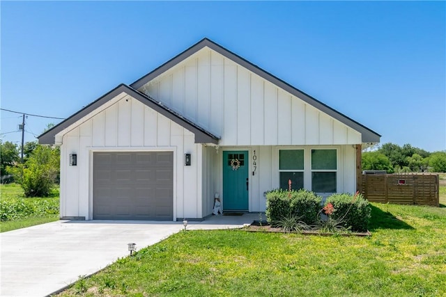 modern farmhouse with an attached garage, board and batten siding, fence, and a front yard