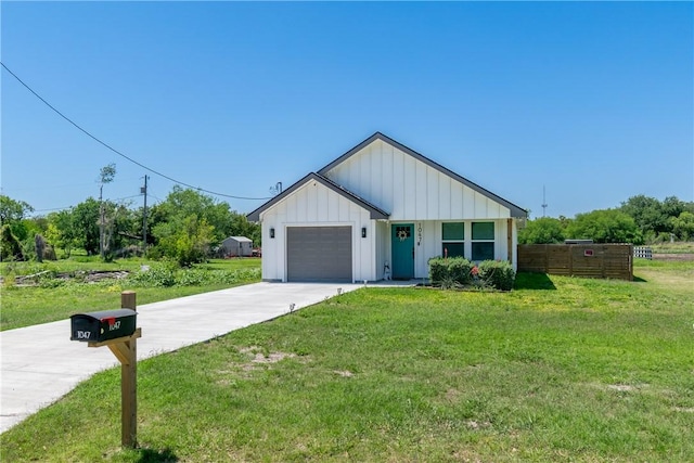 view of front of house featuring an attached garage, a front lawn, board and batten siding, and concrete driveway