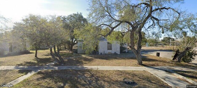obstructed view of property featuring a front lawn